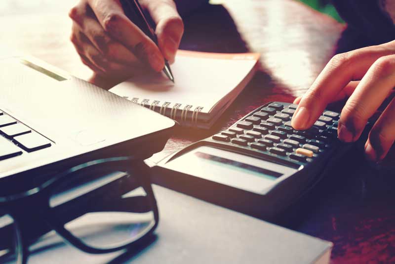 a dental patient calculating the cost of dental implants