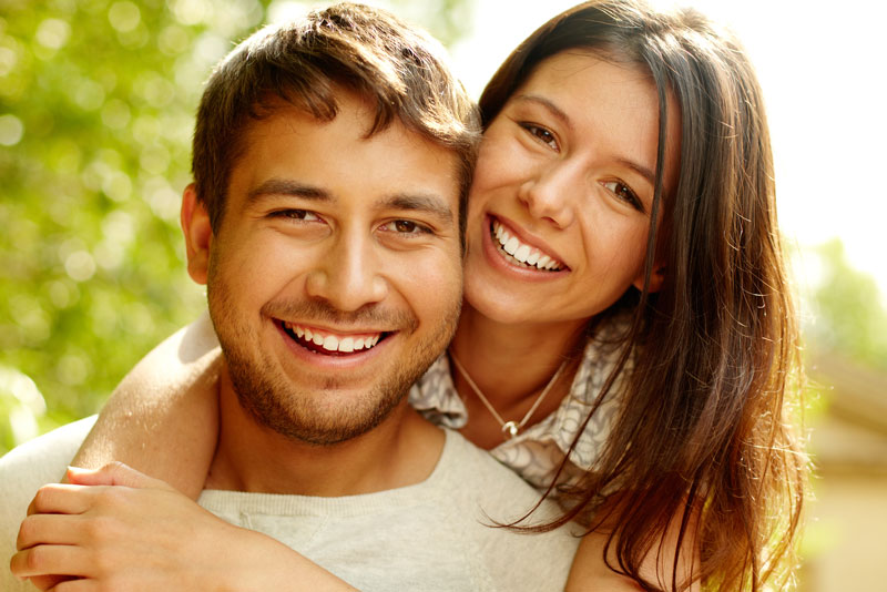 Dental Patients Smiling With Well Cared For Dental Implants In St. Johns, MI