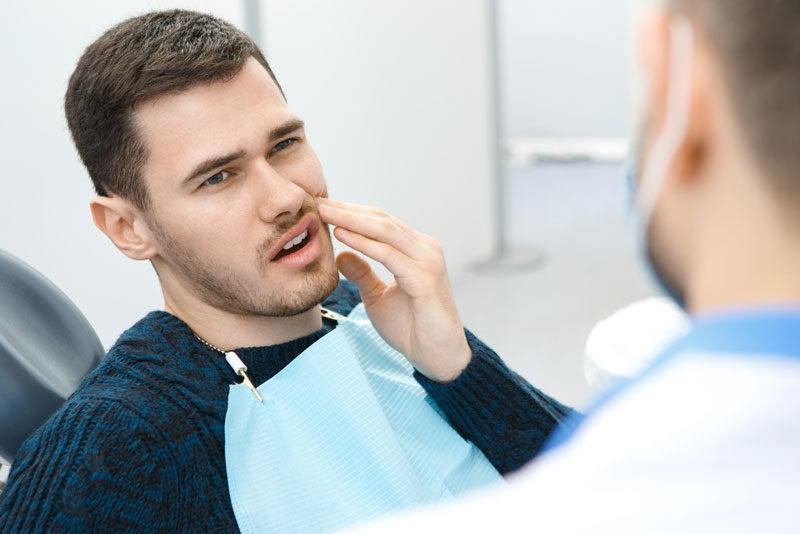 Dental Patient Suffering From Mouth Pain On A Dental Chair, In St. Johns, MI