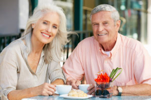 Dental Implant Patients Eating Together With Their False Teeth in St. Johns, MI